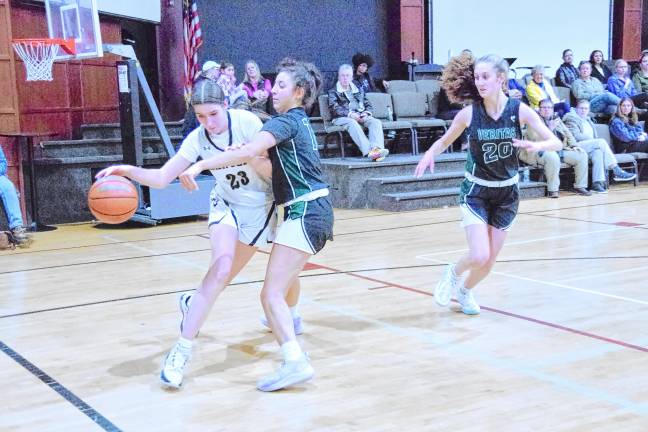 Wallkill Valley's Grace Carr (23) drives past a Veritas defender. She scored four points and grabbed nine rebounds.