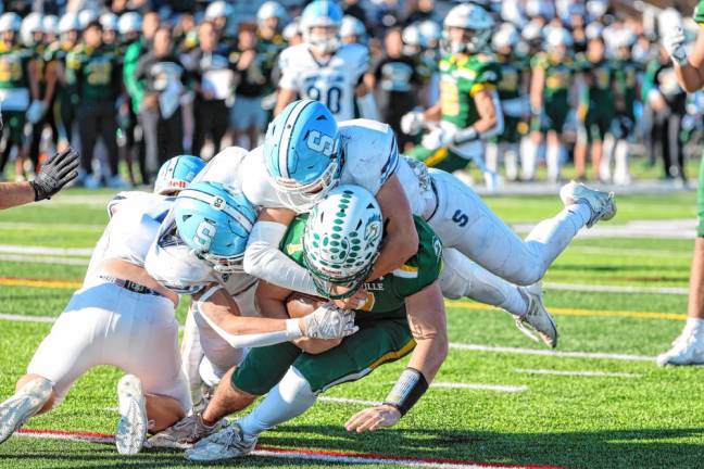 <b>SF2 Sparta’s Brill Lincoln and Brody Tanyeri come together to take down the Montville quarterback for a loss during first-quarter action. (Photo by Glenn Clark)</b>