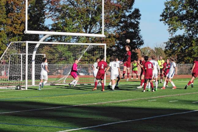 The soccer ball bounces off a Newton Brave's head in front of the Jefferson goalpost.