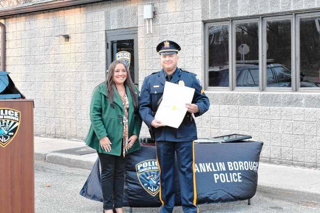 Assemblywoman Dawn Fantasia presents a proclamation to Sgt. Rafael Burgos.