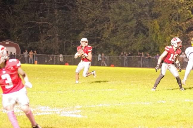 <b>High Point quarterback John Elko carries the ball during a rollout in the first half. Elko passed for 79 yards and made one touchdown. (Photo by George Leroy Hunter)</b>