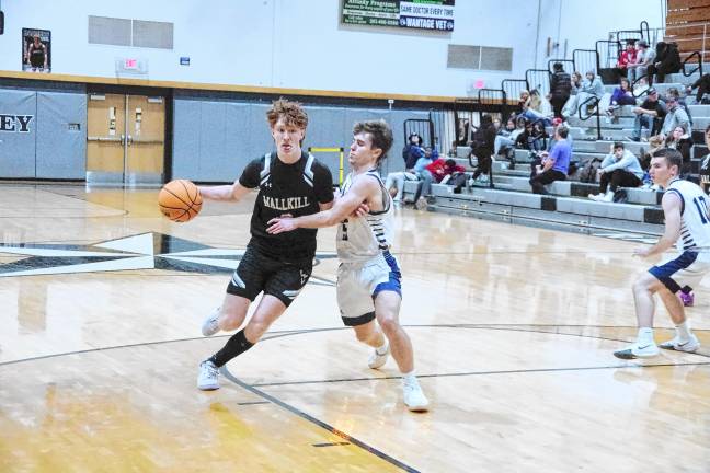 Wallkill Valley's Ryan Geene handles the ball while covered by Sparta's Hayden Kopco. Geene scored three points, grabbed seven rebounds and was credited with three steals.