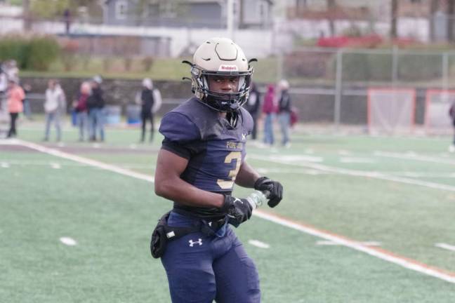 Pope John running back Tylik Hill quenches his thirst during a break in the action.