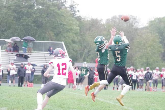 Two Sussex Tech defenders leap in an attempt to intercept the ball in the first half.