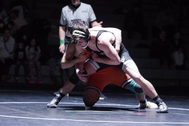 Wallkill Valley's Jacob VanEeuwen, foreground, grapples with Dover's Sergio Galvez in the 157-pound category. Galvez won by pin.