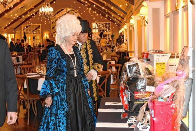 Guests look at items in the silent auction at the Lake Mohawk Country Club in Sparta.