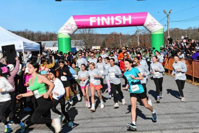 <b>Members of the Girls on the Run program, their running buddies, family members and program alumni take part in the 5K. </b>