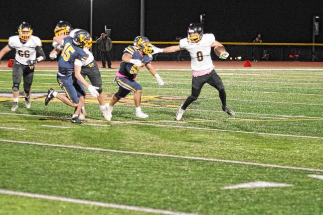 <b>FT3 West Milford ball carrier Chase Tyburczy attempts to evade Vernon defenders.</b>