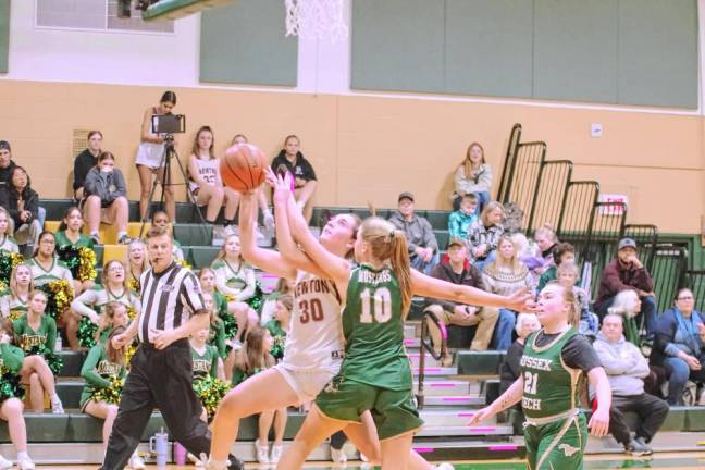 Newton's Caitlyn Pokrywa (30) is fouled by Sussex Tech's Emily Ursin (10) during a shot attempt in the first half of their game Dec. 19. Newton won, 49-20. (Photos by George Leroy Hunter)