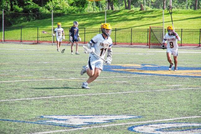 Jefferson's Anthony Giannotti carries the ball with his crosse. He scored one goal against Ramsey.