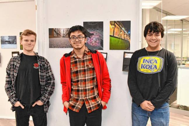 Tyler McCallum, Matthew Henderson and David Fluhr stand in front of their photos on display. (Photo by Maria Kovic)