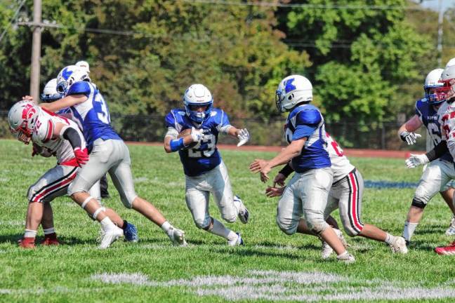 <b>Kittatinny ball carrier Jaden Roberts throws a stiff arm in anticipation of a defender's arrival in the second half. Roberts rushed for 114 yards and made one touchdown.</b>