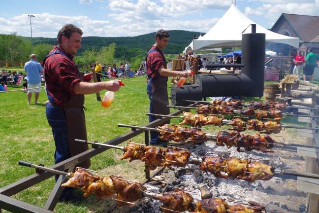Mountain Creek employees Matt Lucenti of Stockholm and Nick Brucato of Franklin put the finishing touches on some three dozen roasting chickens during Mountain Creek&#x2019;s first Smoke&#x2019;N Blues Jazz &amp; Food Festival.