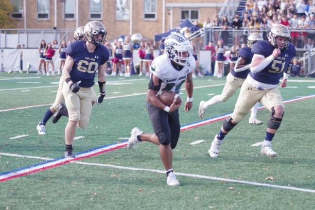 A St. Joseph kick-returner is on the move with Pope John defenders in pursuit.