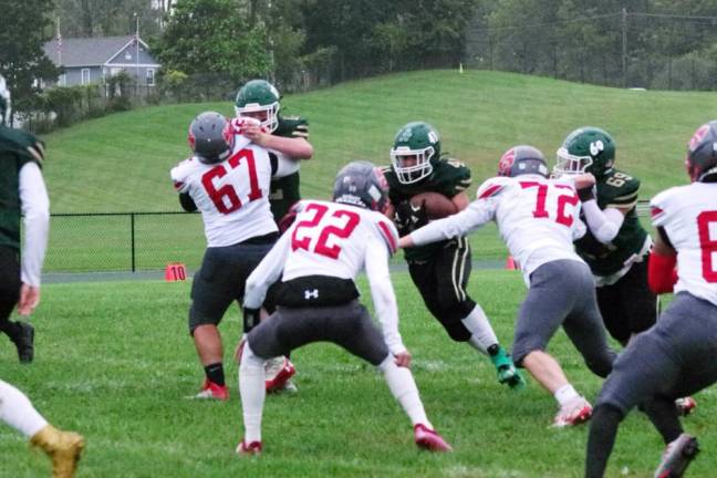 Sussex Tech ball carrier Samuel Fara attempts to break through the High Point defensive line.