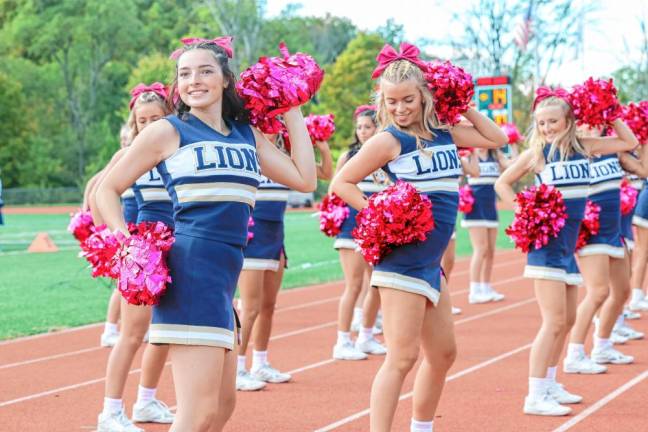 <b>Pope John senior Marissa Marston, left, and her cheer-squad mates on the sidelines.</b>