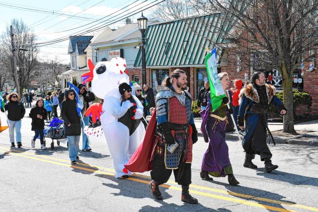 Volunteers at Ginnie’s House Children’s Advocacy Center march in costumes.