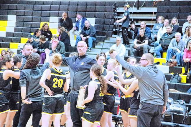 <b>West Milford girls head basketball coach Ray LaCroix, center, gives instructions to players during a break.</b>