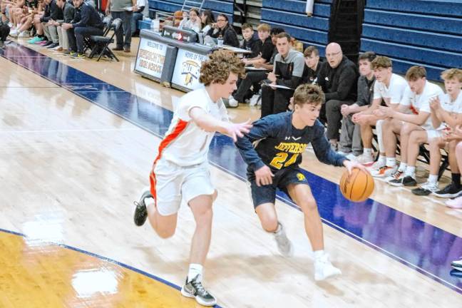 Jefferson's Calen Reid dribbles the ball while covered by Hackettstown's Sean Hall. Reid scored 16 points.