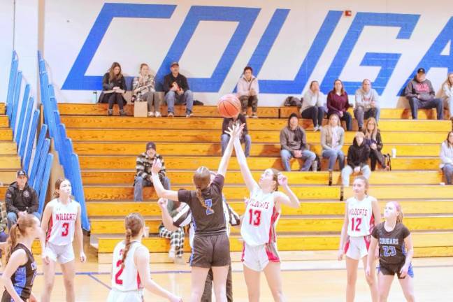 HP2 A Kittatinny Cougar and a High Point Wildcat reach for the ball during the tip-off to start the game.