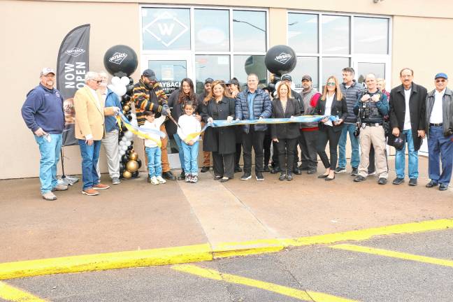 WB1 Wahab Abbasi cuts the ribbon at a ceremony to celebrate the opening of Wayback Burgers in Newton on Thursday, Feb. 27. (Photos by David Warner)