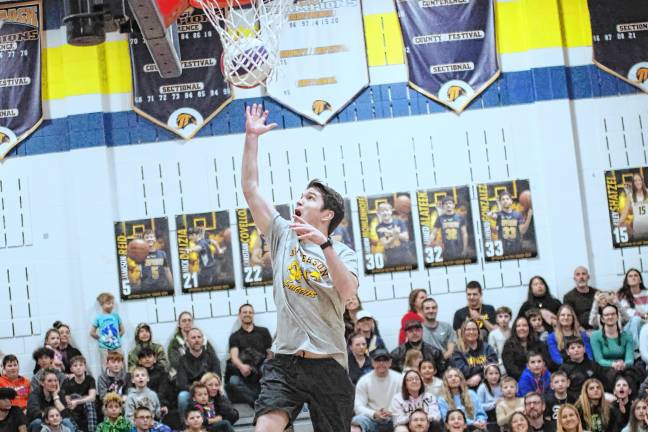 HW3 Jefferson Township Middle School math teacher Robby Toth in the midst of a shot in the first quarter. He scored the first point of the game.