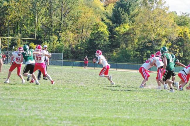 <b>Lenape Valley quarterback Tanner Gaboda is on the run with the ball in the second half. He threw one touchdown pass. (Photo by George Leroy Hunter)</b>