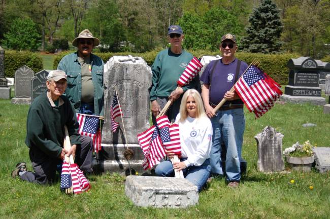 Service Officer Joe Mikowski, Past Commander Clifford Williams, Larry Parr, Ladies Auxiliary member Jackie Sorce and George Pyryt pause in decorating graves at the Oak Ridge Presbyterian Cemetery. They are shown at the grave site of Pvt Ira C. Cooper who served in Company B, 27th Regiment of the NJ Infantry during the Civil War.