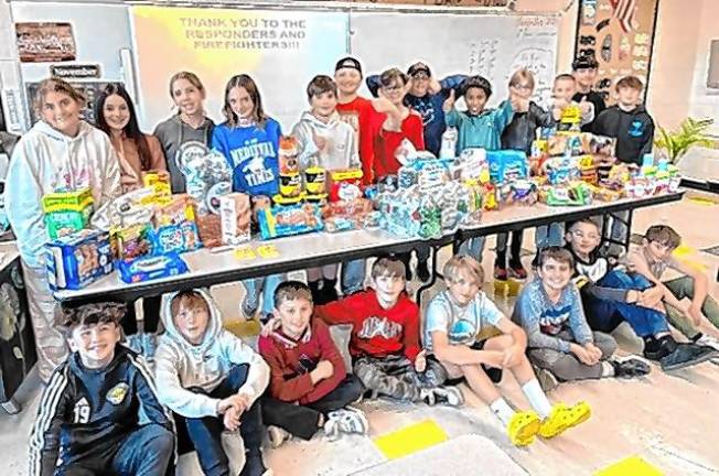 Sixth-grade students at Macopin Middle School in West Milford with items they collected for first-responders fighting the wildfires. (Photo provided)