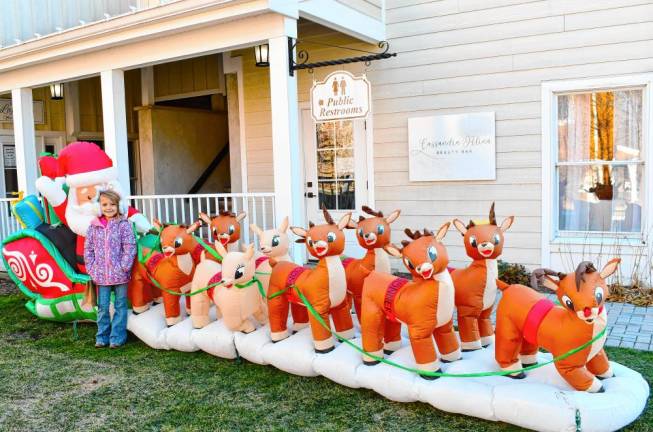 Ellie Opilla of Frankford poses with Santa and his reindeer at Christmas Village at the Shoppes at Lafayette on Saturday, Nov. 30. (Photos by Maria Kovic)