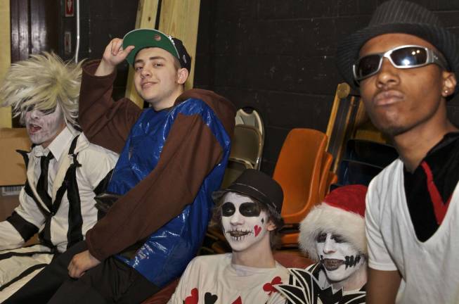 Backstage models and designers pose for a shot before the fashion show. From left, Frank Rocco as Beetlejuice; Niko Soto wears a fabric and duct tape hoodie; Chris Acker dressed as a card; Devon Slockbower as jack Skellington from The Nightmare Before Christmas; Ivan Ballew between costume changes.