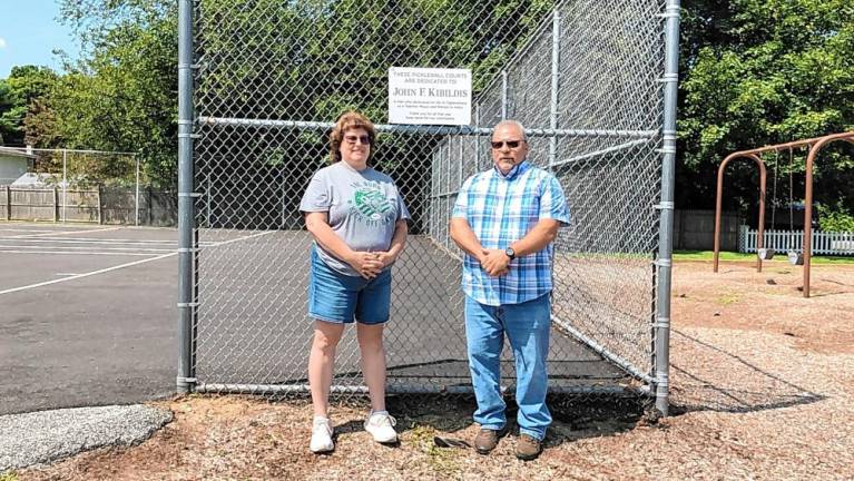 Jane Krueger, president of the Ogdensburg Historical Society, and Mayor George Hutnick stand by the sign posted on the pickleball courts.