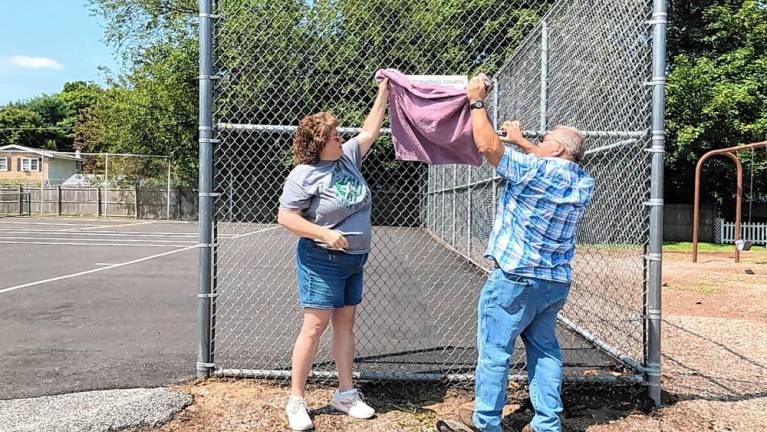 PB1 Jane Krueger, president of the Ogdensburg Historical Society, and Mayor George Hutnick unveil a sign on the pickleball courts Saturday, Aug. 24. (Photos by Kathy Shwiff)