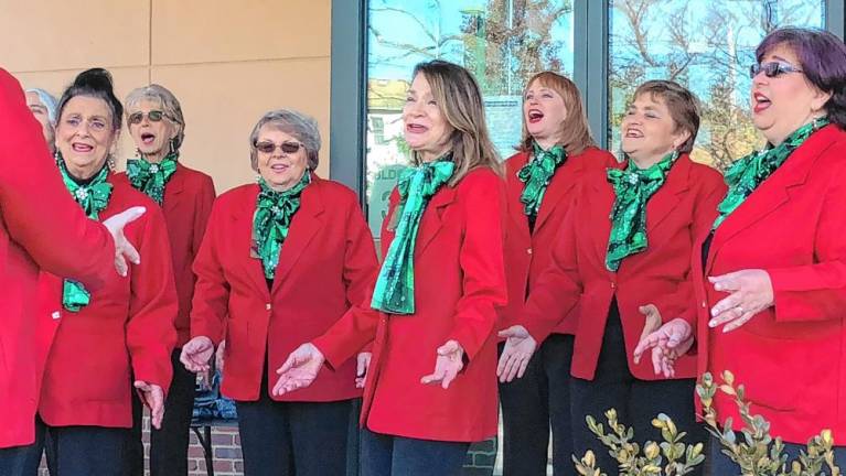 The a cappella group Harmony in Motion sings carols at the event.