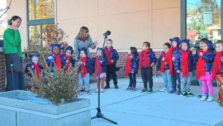 Students at Project Self-Sufficiency’s Little Sprouts Early Learning Center ring bells and sing a holiday song.