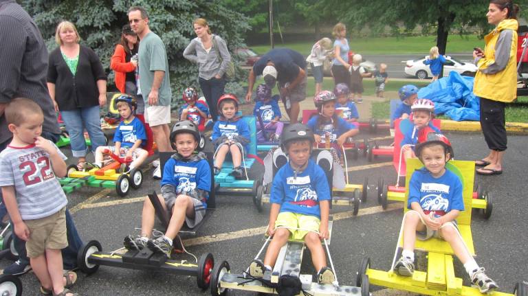 Kids and adults are shown during last year's kart race.