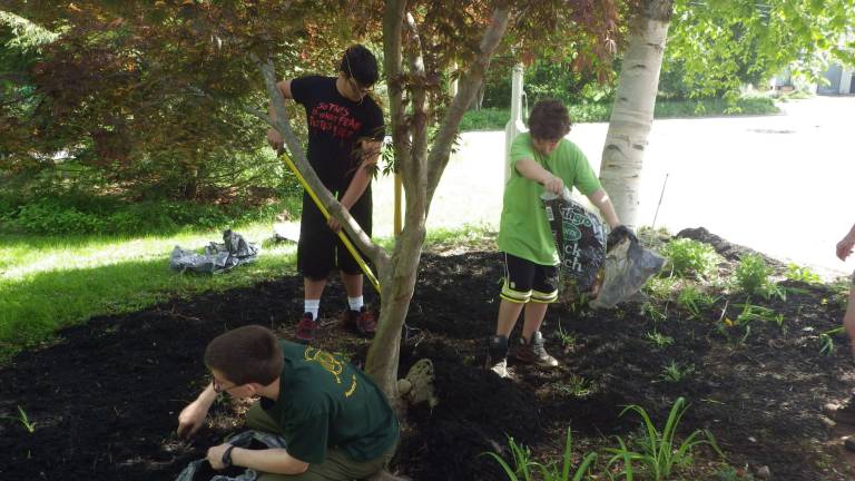 Boy Scout Troop 187 help the Cub Scouts by laying mulch at the Ogdensburg First Aid Squad for Memorial Day.