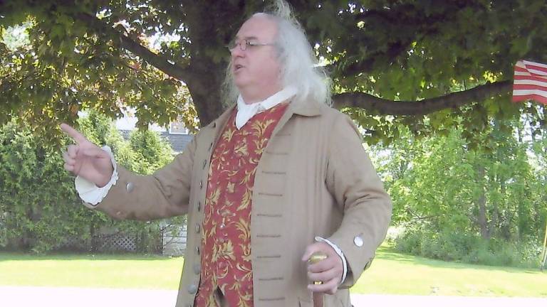 Robert DeVitis (a.k.a. Benjamin Franklin) makes the crowd chuckle with his humorous observations of the 1770s (Photo by Janet Redyke)