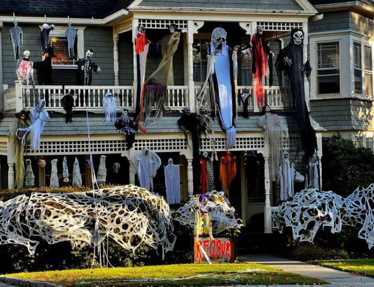 $!<b>Spider webs and spirits adorn the entrance of this house on Murray Ave., Goshen NY. In addition, a sign spelling ‘Murder’ backwards pays homage to the horror classic “The Shining.”</b>